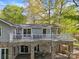 Home featuring stone accents, arched openings, and a charming balcony with patio set at 501 Nivens Cove Rd, Mount Holly, NC 28120