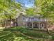 Stunning home featuring stone accents, a charming balcony, and lush greenery at 501 Nivens Cove Rd, Mount Holly, NC 28120