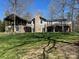 Stunning home featuring stone accents, a charming balcony, and lush greenery at 501 Nivens Cove Rd, Mount Holly, NC 28120