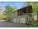 Home featuring stone accents, covered veranda, and attached garage at 501 Nivens Cove Rd, Mount Holly, NC 28120
