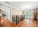 Bright foyer with hardwood floors, decorative railing, and stylish front door at 501 Nivens Cove Rd, Mount Holly, NC 28120