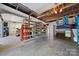Spacious garage with shelving and a variety of items, offering ample storage and organization at 501 Nivens Cove Rd, Mount Holly, NC 28120