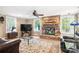Bright living room with stone fireplace, ceiling fan, and hardwood floors at 501 Nivens Cove Rd, Mount Holly, NC 28120