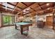 Expansive recreation room with pool table, bar area, fireplace, and outdoor access at 501 Nivens Cove Rd, Mount Holly, NC 28120