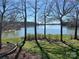 Scenic water view with mature trees on a sunny day at 501 Nivens Cove Rd, Mount Holly, NC 28120