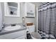 Small bathroom with shower, vanity, and striped curtain at 3220 Sawmill Rd, Hickory Grove, SC 29717