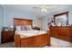 Bedroom with wooden bed frame, dresser, and ceiling fan at 3220 Sawmill Rd, Hickory Grove, SC 29717