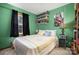 Green bedroom with a bed and a collection of collectables at 3220 Sawmill Rd, Hickory Grove, SC 29717