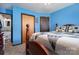 Blue bedroom with a wooden bed frame and a view of the bathroom at 3220 Sawmill Rd, Hickory Grove, SC 29717