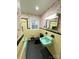 A retro bathroom features yellow tile, black trim, colorful wallpaper, and a green sink and tub at 612 Brown Ave, Albemarle, NC 28001
