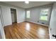Bedroom features two windows for natural light, hardwood floors, and a spacious closet at 612 Brown Ave, Albemarle, NC 28001
