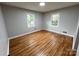 Bedroom features two windows for natural light and beautiful hardwood floors at 612 Brown Ave, Albemarle, NC 28001