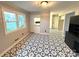 Stylish dining area features bold, patterned flooring and seamless connectivity to the kitchen at 612 Brown Ave, Albemarle, NC 28001