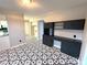 Trendy dining space showcasing patterned floors and built-in desk with a view of the kitchen and doorway at 612 Brown Ave, Albemarle, NC 28001