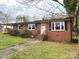 Charming brick home featuring a classic design with a well-maintained lawn and inviting front entrance at 612 Brown Ave, Albemarle, NC 28001