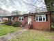 Charming brick home with a well-manicured front yard and inviting front porch at 612 Brown Ave, Albemarle, NC 28001