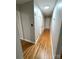 Hallway with hardwood floors, white doors and trim, and ample storage at 612 Brown Ave, Albemarle, NC 28001