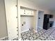 A functional laundry area with overhead cabinets and stylish black and white patterned flooring at 612 Brown Ave, Albemarle, NC 28001