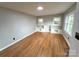 Bright living room featuring hardwood floors, built-in shelves and ample natural light from two large windows at 612 Brown Ave, Albemarle, NC 28001