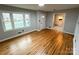 Inviting living room with hardwood floors, large windows, and seamless transition to other areas at 612 Brown Ave, Albemarle, NC 28001