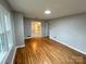 Spacious living room showcasing gleaming hardwood floors and fresh paint, creating a welcoming space at 612 Brown Ave, Albemarle, NC 28001