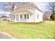 Quaint home with a brick facade, covered porch, and lush green lawn at 405 Aquadale Rd, Albemarle, NC 28001