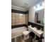 Modern bathroom featuring tile walls, a bathtub and shower, and a sleek vessel sink at 235 E Moore St, Rock Hill, SC 29730