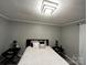 Bedroom with a bed dressed with decorative pillows, nightstands and modern light fixture at 235 E Moore St, Rock Hill, SC 29730