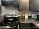 A well-equipped kitchen featuring stainless steel appliances and sleek black cabinetry at 235 E Moore St, Rock Hill, SC 29730