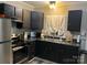 A well-equipped kitchen featuring stainless steel appliances and sleek black cabinetry at 235 E Moore St, Rock Hill, SC 29730