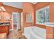 Bathroom with double vanity, soaking tub, and a window offering natural light at 121 Pebble Creek Dr, Stony Point, NC 28678