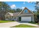 Charming home with a two-car garage and inviting front porch, showcasing lovely curb appeal at 121 Pebble Creek Dr, Stony Point, NC 28678