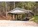 Covered picnic pavilion with tables and benches lakeside at 121 Pebble Creek Dr, Stony Point, NC 28678