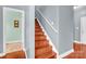 Elegant wooden staircase with gray walls and hardwood floors at 121 Pebble Creek Dr, Stony Point, NC 28678