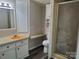 Bathroom features a white vanity, beige countertop, and standing shower at 230 Ellen St, Salisbury, NC 28146