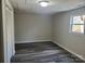 A comfortable bedroom with wood-look flooring, natural light, and a spacious closet at 230 Ellen St, Salisbury, NC 28146