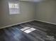 A bright bedroom with modern wood-look floors and a sunlit window at 230 Ellen St, Salisbury, NC 28146