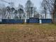 Single-story blue home featuring wood shutters and a gravel yard at 230 Ellen St, Salisbury, NC 28146