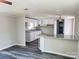 Bright open kitchen features white cabinets, granite countertops, and gray wood-look floors at 230 Ellen St, Salisbury, NC 28146