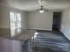 Open-concept living room featuring gray wood-look floors and granite-topped breakfast bar at 230 Ellen St, Salisbury, NC 28146