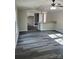 Spacious living room featuring gray wood-look floors, abundant natural light, and a breakfast bar at 230 Ellen St, Salisbury, NC 28146