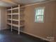 Empty room with built-in shelving and a window providing natural light at 230 Ellen St, Salisbury, NC 28146