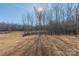 Private backyard with a black metal fence and mature trees at 1229 Red River Dr, Salisbury, NC 28144