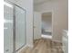 Modern bathroom featuring a glass shower and wood-look floors at 1229 Red River Dr, Salisbury, NC 28144