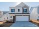 Two-story house with neutral siding and a white garage door at 1229 Red River Dr, Salisbury, NC 28144