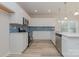Modern kitchen with white cabinets, stainless steel appliances, and blue tile backsplash at 1229 Red River Dr, Salisbury, NC 28144