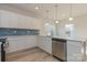 Modern kitchen with white cabinets, stainless steel appliances, and blue tile backsplash at 1229 Red River Dr, Salisbury, NC 28144