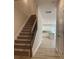 Modern staircase with metal balusters leading to kitchen at 1229 Red River Dr, Salisbury, NC 28144