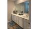Bright bathroom featuring double sinks, white cabinetry, and modern fixtures at 110 Silver Oak Cir, Rockwell, NC 28138