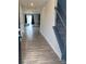 Inviting entryway with wood-look flooring leading to the living area and staircase with wooden railing at 110 Silver Oak Cir, Rockwell, NC 28138